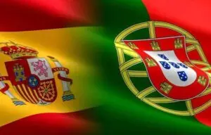Bandeiras de Espanha e Portugal sobrepostas, comparando os caminhos para portadores de rendimentos próprios em cada país.